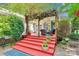 Charming back porch with a pergola covered in vines, offering an ideal space for relaxation and outdoor dining at 666 Tryon Pl, Gastonia, NC 28054