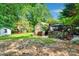 Spacious backyard featuring a brick outdoor kitchen, covered patio, and play area for children at 666 Tryon Pl, Gastonia, NC 28054