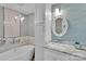Bright bathroom features a soaking tub, patterned tile accent wall, and white vanity with a decorative mirror at 666 Tryon Pl, Gastonia, NC 28054