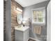 Bathroom featuring stone accent wall, marble countertop vanity, and brushed gold fixtures at 666 Tryon Pl, Gastonia, NC 28054