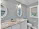 Bright bathroom with a double sink vanity, decorative mirrors, and elegant lighting fixtures at 666 Tryon Pl, Gastonia, NC 28054