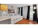 Cozy bedroom featuring hardwood floors, built-in storage, modern lighting, and a relaxing atmosphere at 666 Tryon Pl, Gastonia, NC 28054