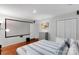 This inviting bedroom boasts a large screen, neutral paint, and hardwood floors at 666 Tryon Pl, Gastonia, NC 28054