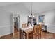 Bright dining room featuring a wooden table, vaulted ceilings, and seamless flow to kitchen and living room at 666 Tryon Pl, Gastonia, NC 28054