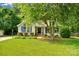 Well-maintained home with lush front lawn, complemented by mature trees providing ample shade at 666 Tryon Pl, Gastonia, NC 28054