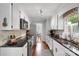 Galley kitchen featuring granite counters, white cabinets, stainless steel appliances, and hardwood floors at 666 Tryon Pl, Gastonia, NC 28054