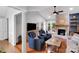 Cozy living room with a brick fireplace, vaulted ceilings, and built-in shelving, creating a warm ambiance at 666 Tryon Pl, Gastonia, NC 28054