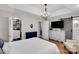 Bright main bedroom boasts hardwood floors, an elegant chandelier, and ensuite bathroom access at 666 Tryon Pl, Gastonia, NC 28054