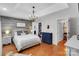 Serene main bedroom with a decorative light fixture, a walk-in closet, and hardwood floors at 666 Tryon Pl, Gastonia, NC 28054