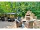 Inviting outdoor patio with a stunning brick fireplace, comfortable seating, and a dining area perfect for gatherings at 666 Tryon Pl, Gastonia, NC 28054
