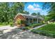 Beautiful brick home with a well-manicured lawn and colorful hydrangea bushes lining the walkway at 701 4Th Ne Ave, Conover, NC 28613