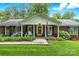 Charming red brick home with an inviting front porch, American flag, and flowering shrubs at 701 4Th Ne Ave, Conover, NC 28613
