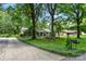 Brick home with lush landscaping, mature trees, and long driveway at 701 4Th Ne Ave, Conover, NC 28613