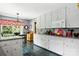 Bright kitchen offers white cabinets, granite counters, and open view into dining area at 701 4Th Ne Ave, Conover, NC 28613