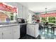 Bright kitchen with white cabinets, granite countertops, and a view into the adjacent dining area at 701 4Th Ne Ave, Conover, NC 28613