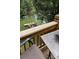 View of a wood deck with outdoor seating overlooking a lush waterfront and private boat dock at 729 Victoria Ln, Hickory, NC 28601
