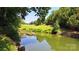 A wooden dock overlooking a beautiful green lake and a grassy field at 729 Victoria Ln, Hickory, NC 28601