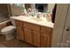 Bathroom featuring a single sink vanity with wooden cabinets, tile flooring, and mirrored wall cabinet at 729 Victoria Ln, Hickory, NC 28601