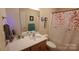 Bathroom featuring a shower-tub combination with floral shower curtain and tile flooring at 729 Victoria Ln, Hickory, NC 28601