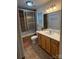 Bathroom showcasing a tiled shower with glass door, vanity with bright lighting, and decorative mirror at 729 Victoria Ln, Hickory, NC 28601