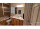 Bathroom featuring a single sink vanity, mirrored wall, framed shower, and neutral color palette at 729 Victoria Ln, Hickory, NC 28601