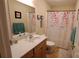 Bathroom features a shower-tub combination with floral shower curtain and wooden vanity at 729 Victoria Ln, Hickory, NC 28601