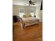 Bedroom with hardwood floors, two windows and a comfortable bed with decorative pillows at 729 Victoria Ln, Hickory, NC 28601