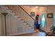 Bright entryway featuring a front door with oval window, stairs with iron railing, and wood flooring at 729 Victoria Ln, Hickory, NC 28601