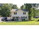 Charming two-story home with a well-manicured lawn and a lake view in the backyard at 729 Victoria Ln, Hickory, NC 28601