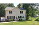 Charming two-story home with black shutters and lush green lawn near the lake at 729 Victoria Ln, Hickory, NC 28601