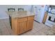 A granite-countered island with wood cabinets in the kitchen of the home at 729 Victoria Ln, Hickory, NC 28601