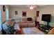 Comfortable living room boasts a large sectional sofa, area rug, natural lighting, and entertainment center at 729 Victoria Ln, Hickory, NC 28601