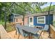 Inviting back deck area with overhead pergola, table, chairs, and string lights for outdoor relaxation and entertaining at 742 Stonecrest Dr, Statesville, NC 28625