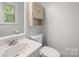Well-lit bathroom with a white vanity, toilet, and neutral walls at 742 Stonecrest Dr, Statesville, NC 28625