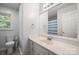 Bathroom with a white vanity, sink, and mirror, complemented by a toilet and tiled floor at 742 Stonecrest Dr, Statesville, NC 28625