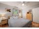 Comfortable bedroom with neutral walls, wood floors, natural light, ceiling fan, and soft bedding at 742 Stonecrest Dr, Statesville, NC 28625