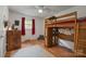 Bedroom featuring built-in wooden loft and desk, with wood floors, a ceiling fan, and neutral decor at 742 Stonecrest Dr, Statesville, NC 28625