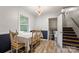 Charming dining area with a large window and staircase creating a warm atmosphere at 742 Stonecrest Dr, Statesville, NC 28625
