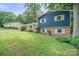 Beautiful blue home on a lush green lawn surrounded by mature trees in a neighborhood at 742 Stonecrest Dr, Statesville, NC 28625