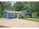 Charming blue home with brick accents, inviting landscaping, and a spacious driveway at 742 Stonecrest Dr, Statesville, NC 28625