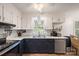 Charming kitchen features updated counters, white cabinets, and stainless steel dishwasher at 742 Stonecrest Dr, Statesville, NC 28625