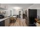 Well-lit kitchen with stainless steel appliances and an adjacent dining room, ideal for gatherings at 742 Stonecrest Dr, Statesville, NC 28625