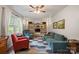 Cozy living room featuring hardwood floors, a ceiling fan, and comfortable seating at 742 Stonecrest Dr, Statesville, NC 28625