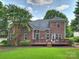 Charming brick home featuring a spacious wooden deck and well-manicured lawn perfect for outdoor entertaining at 901 Deercross Ln, Waxhaw, NC 28173