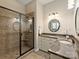 Bathroom featuring granite counters, dual sinks, a large walk-in shower with bench seating and tile surround at 901 Deercross Ln, Waxhaw, NC 28173