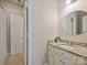 Bright bathroom with granite countertop, round mirror, and tile flooring at 901 Deercross Ln, Waxhaw, NC 28173