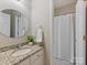 Bathroom features granite countertop, round mirror, and a shower with a white curtain at 901 Deercross Ln, Waxhaw, NC 28173