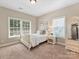 Cozy bedroom with a white bed, two windows, and a decorative armoire at 901 Deercross Ln, Waxhaw, NC 28173