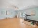 Bonus room with blue-green walls, wood floors, ceiling fan, windows with blinds and an exercise area at 901 Deercross Ln, Waxhaw, NC 28173