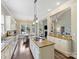 Open kitchen features an island with cooktop, granite countertops, stainless steel appliances, and hardwood floors at 901 Deercross Ln, Waxhaw, NC 28173